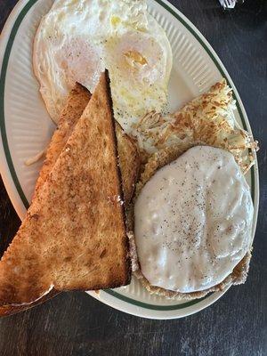 Chicken fried steak over easy eggs, hash