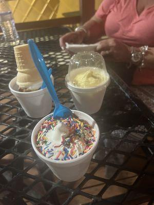 Small vanilla ice cream with rainbow sprinkles , small dole shop and and small vanilla with chocolate dip.