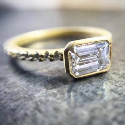 Emerald Cut Diamond set Horizontally in a yellow gold pave setting