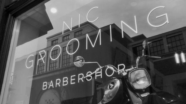 A view of Nic Grooming Barber Shop Chestnut Street's storefront from the exterior.