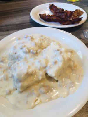 Biscuit and gravy with a side of bacon during their brunch special