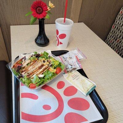 Southwest Salad w/ grilled chicken breast, in a comfy booth.