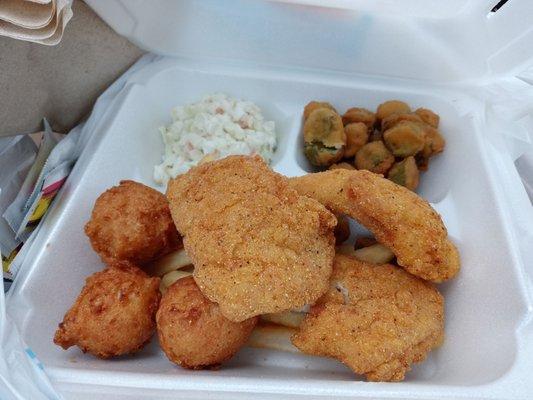 Three pieces of catfish with fried okra, 2 hush puppies, cole slaw and fries (under the catfish). Easily enough for two meals.