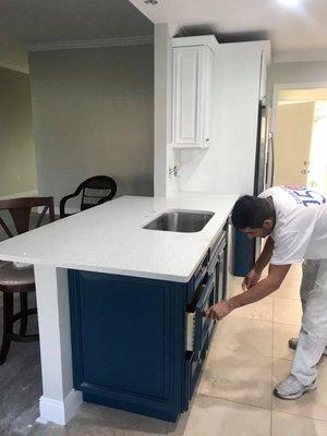 After- Gray Owl on the walls, White Upper Cabinets, Navy Bottom Cabinets, White Backsplash.