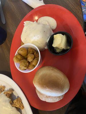 Mashed potatoes , okra and bread on the side