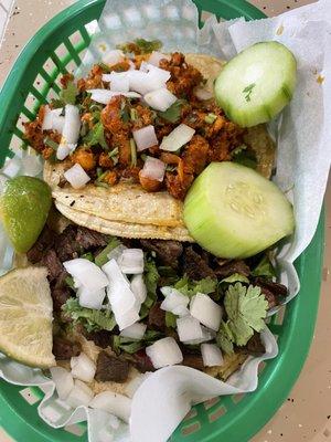 El pastor taco (top) and Asada taco (bottom) with onions and cilantro