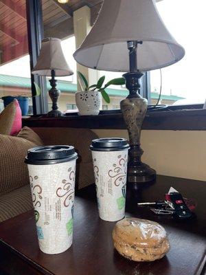 Two cups and cookies in front of lanp