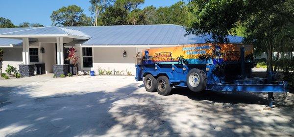 Dump trailer delivered to jobsite. 3500 sq ft of porcelain tile.