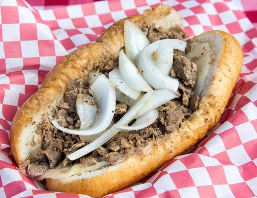 Authentic Philly Cheese Steak - Seasoned Chip Rib-Eye Steak with Grilled Onions on a Hand-Crafted Roll.