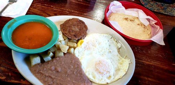 My Huevos Rancheros with sausage patty and corn tortillas substituting for bacon and flour tortillas. I has my eggs over medium.