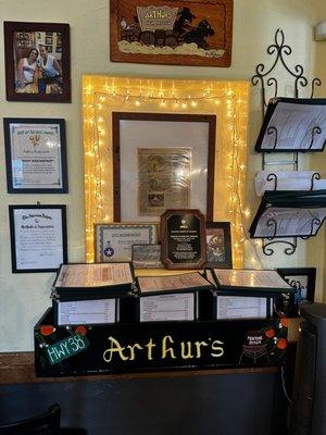 Wall with awards given to Arthurs Restaurant.