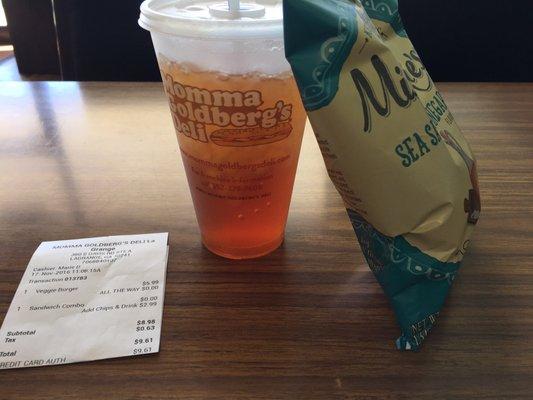 Sweet tea in a souvenir plastic cup with salt and vinegar chips. My total for the sandwich with a chips and drink combo was $9.61.