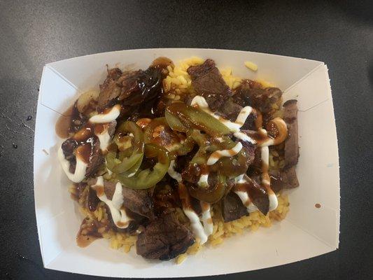 Brisket over rice with sour cream (?), pickled jalapeños and a sweet & savory bbq sauce.