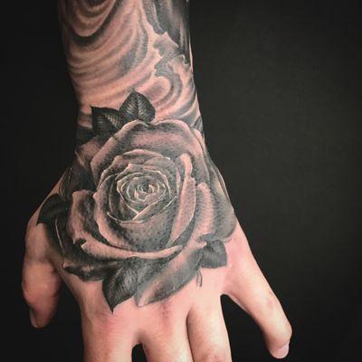 Rose tattoo on a hand done by Oksana Weber