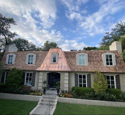 A cedar shake roof with copper gutters and copper roof!  Absolutely stunning!