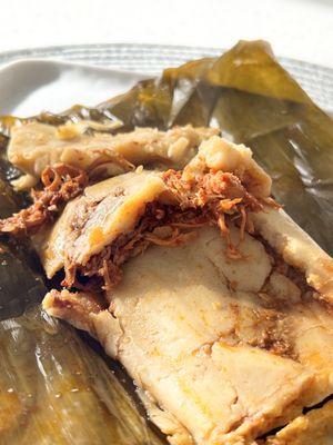 Chicken Rojo Tamales wrapped in banana leaf