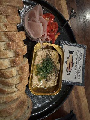 Tin of salmon with bread and pickled shallots and Fresno chilies.