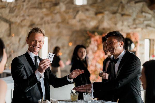 Strolling / close-up magic during cocktail hour for a wedding at The American Club.