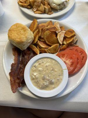 Biscuit and Gravy with bacon, sliced tomatoes and home fries