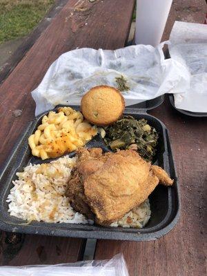 Fried chicken, rice with gravy, greens and Mac n cheese.