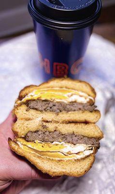 Sausage, eggs & cheese on a HBC brioche bun w/ a large hot coffee - takeout, it has 2 eggs and Italian style sausage- nice!!