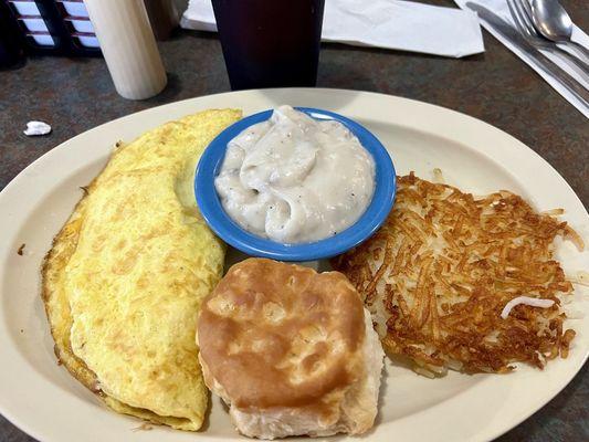 Ham and Cheese omelet, biscuit, sausage gravy and hashbrowns, well done.