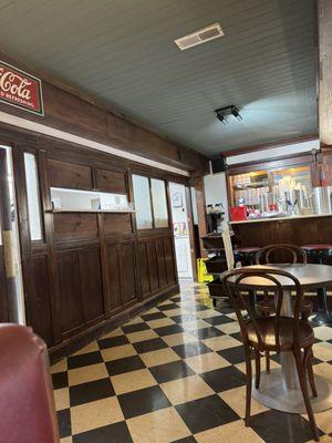 Doors to the kitchen and end of the soda fountain stools.