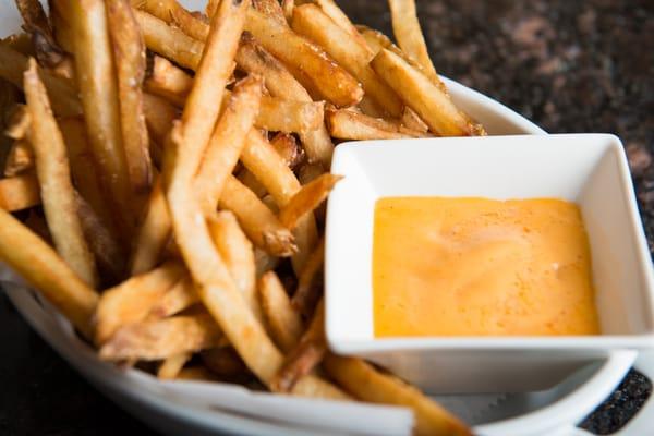 Hand cut fries with smoked cheddar sauce.