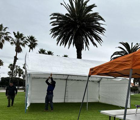 Antonio and his son putting up the beautiful canopy tent for our party