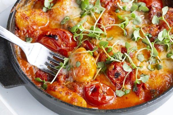 GNOCCHI SORRENTINA with baked gnocchi, San Marzano pomodoro Sauce, eggplants, Calabrian chili, mozzarella di bufula, parmigiano & basil