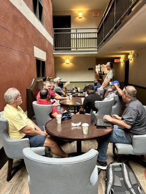 An impromptu team meeting on the mezzanine level.