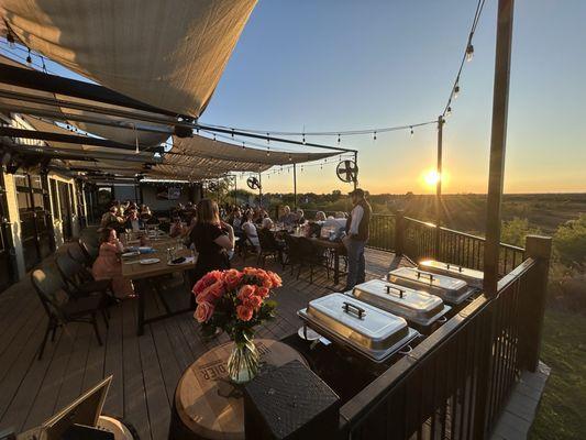 Our buffet setup, guests, and the beautiful sunset over the lake.