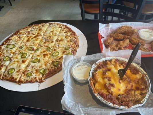 Pizza and breaded wings and cheese fries with bacon