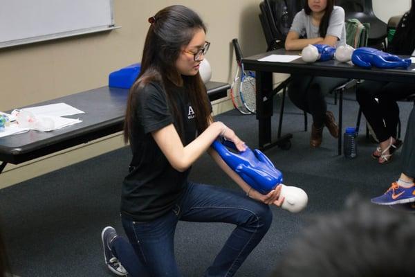 Instructor Kristin demonstrating choking relief for an infant