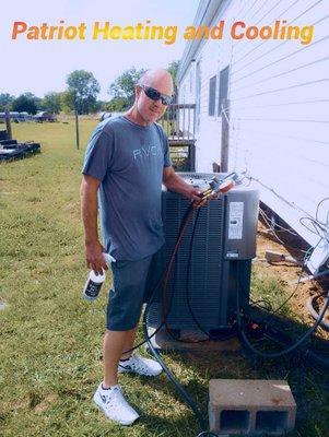 Technician checking gauges after replacing unit.