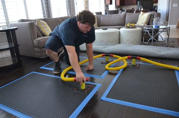 Here is a flooring-mat extraction setup. The panels dry wet areas by pulling moisture through the panel joints.