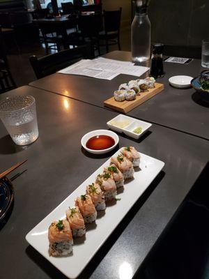 Foreground: 2022 roll, w/lightly seared salmon and a garlic salmon inside. Back: Alaska Roll.