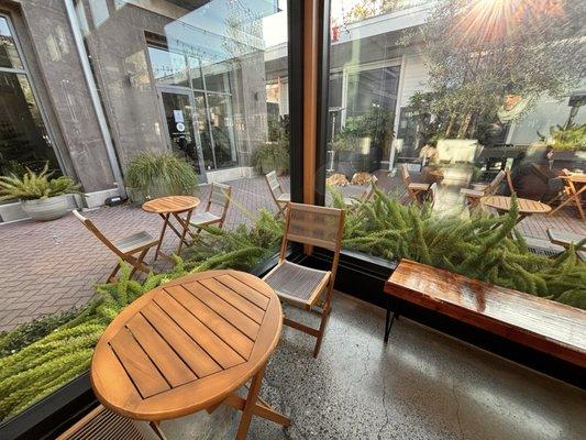 Inside the corner bistro looking out to the other outdoor bistro tables and surroundings at Moulin