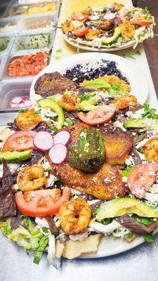 Tlayudas, cecina, Tilapia, Shrimp, lettuce, mash blacj Beans, lettuce, quesillo(queso Oaxaca) and tomatos