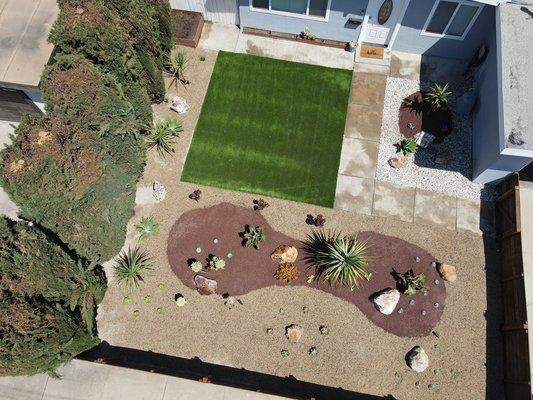 Complete redesign of front yard, artificial grass, plants/shrubs installation, rocks/boulders, and fence installation.