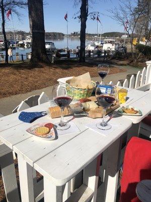 Nice assortment of meats and cheeses with a couple bottles of wine--lakeside!