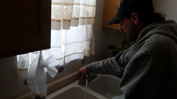 James is shown here washing his hands prior to starting our packing service in Kenosha Wisconsin.