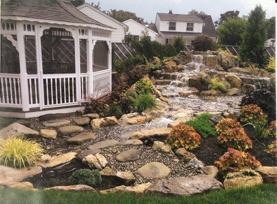 A larger pondless waterfall with a stream