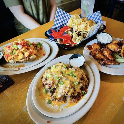 Loaded baked potatoes, wings, tacos