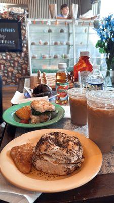 Bacon, egg, & cheese everything bagel & a hash brown. Spinach, onion, egg, & cheese onion bagel. Cold brew coffees & a chocolate muffin.