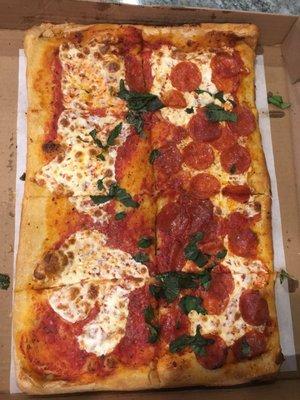 Margarita pizza with half added pepperoni