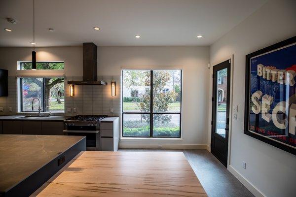 Vanderbilt Project: Contemporary styled kitchen with an an affixed kitchen table on the island.