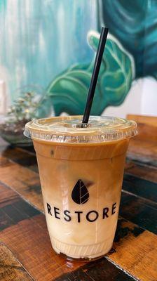 Iced latte with oat milk and honey