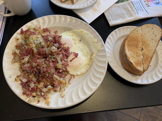 Nicely seasoned corn Corned Beef Hash & Eggs over easy, with thick rye toast.