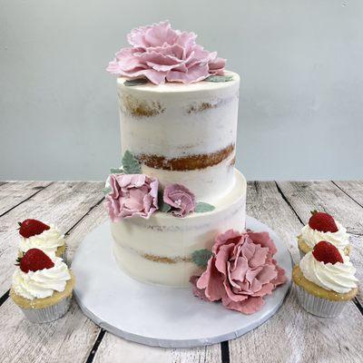 Naked cake with flowers and cupcakes